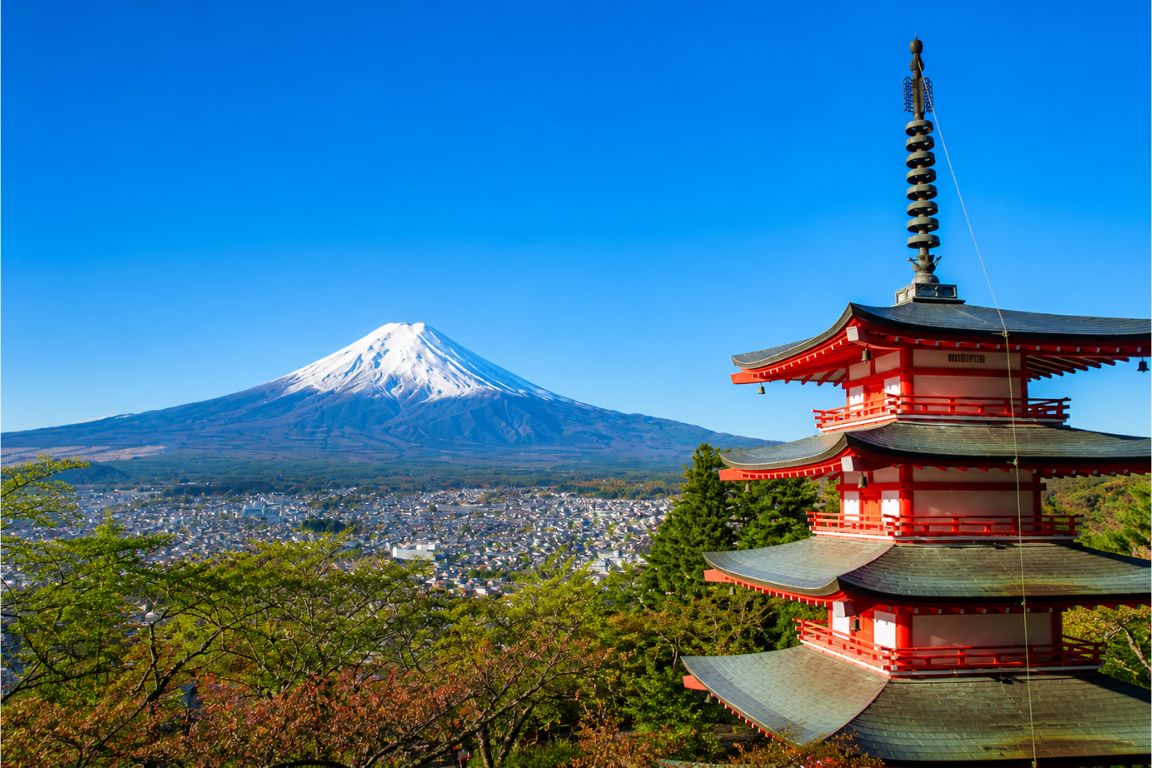 Scenic view of Chureito Pagoda and Mount Fuji with city below during a Mt. Fuji Tours experience with our agency