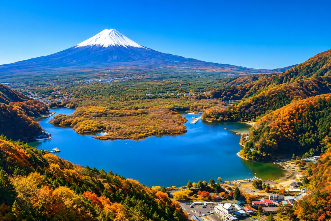 Panoramic view of the Fuji Five Lakes area with Mount Fuji and colorful autumn foliage during a Mt. Fuji Tours guided experience with our agency