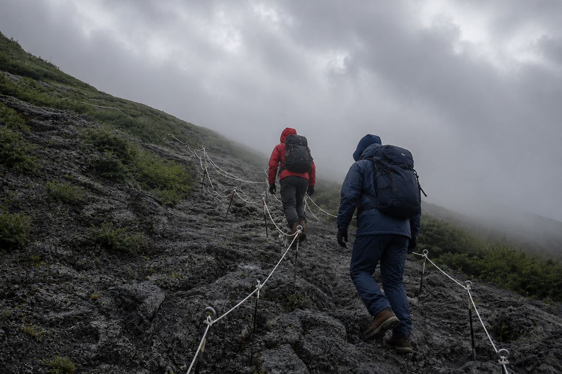 Adventure hiking scene on Yoshida Trail with climbers ascending Mount Fuji during a Mt. Fuji Tours tour with our agency