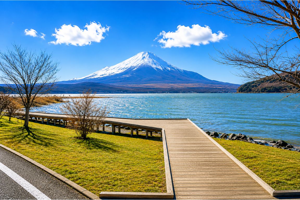 Beautiful Lake Yamanaka shoreline with wooden boardwalk and Mount Fuji during a Mt. Fuji Tours tour with our agency